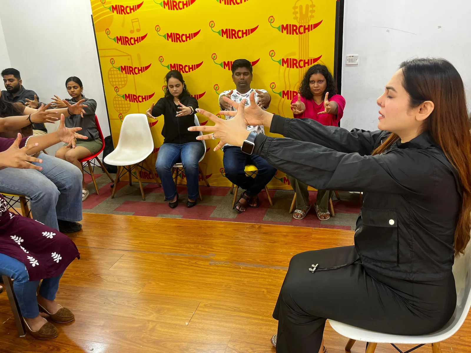 Vibha Jain demonstrating a guided focused-attention exercise to a seated group during an awareness session