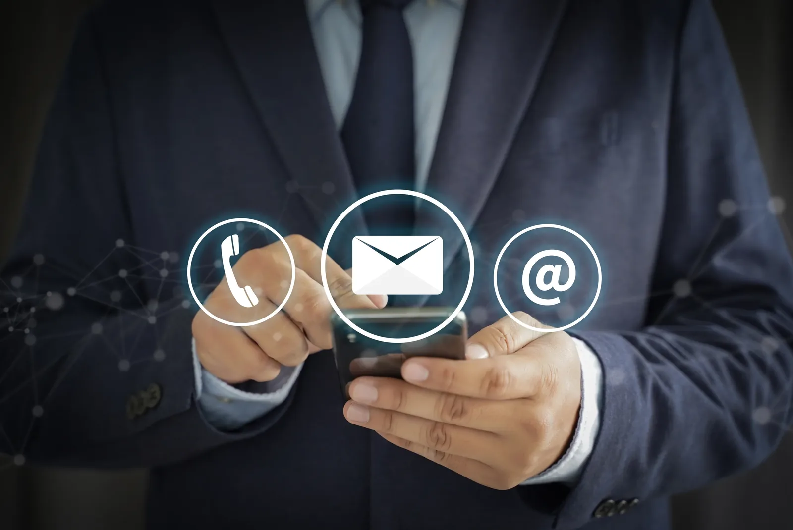 A person holding a phone with call and email icons alongside, representing getting in touch with a professional